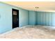 Covered carport area with freshly painted blue walls and a secure black front door at 2258 E Alpine Ave, Mesa, AZ 85204