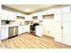 Beautiful kitchen features modern appliances, sleek white cabinets, and new flooring at 2258 E Alpine Ave, Mesa, AZ 85204