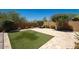 View of the backyard showcasing travertine pavers, artificial turf, and lush landscaping on a sunny day at 2321 W Brookhart Way, Phoenix, AZ 85085