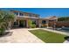 Beautifully landscaped backyard features travertine patio, artificial turf, pool, and raised spa with ample entertaining space at 2321 W Brookhart Way, Phoenix, AZ 85085
