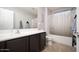 Clean bathroom features a bath, shower, large mirror, and dark wood vanity at 2321 W Brookhart Way, Phoenix, AZ 85085