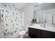 Clean bathroom with modern vanity, toilet, mirror, and shower with colorful decorative curtain at 2321 W Brookhart Way, Phoenix, AZ 85085