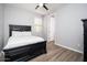 Cozy bedroom featuring wood-look floors, a ceiling fan, and a dark-colored bed frame at 2321 W Brookhart Way, Phoenix, AZ 85085