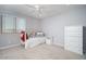Bright bedroom with a ceiling fan, plush carpeting, and an elegant white dresser at 2321 W Brookhart Way, Phoenix, AZ 85085