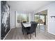 Formal dining room with slider door access to the backyard, modern chandelier and dark accents at 2321 W Brookhart Way, Phoenix, AZ 85085