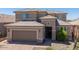 Well-maintained two story house with beautiful landscaping, tile roof, and tan exterior paint at 2321 W Brookhart Way, Phoenix, AZ 85085