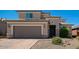 Charming two-story home features a paver driveway, tan stucco, and a two-car garage at 2321 W Brookhart Way, Phoenix, AZ 85085