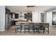 Spacious kitchen with dark cabinets, stainless appliances, large island and bar stool seating at 2321 W Brookhart Way, Phoenix, AZ 85085
