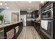 Modern kitchen with stainless steel appliances, dark cabinetry, and granite countertops at 2321 W Brookhart Way, Phoenix, AZ 85085