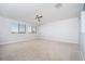 Open-concept living room featuring plush carpeting, neutral walls, and great natural light at 2321 W Brookhart Way, Phoenix, AZ 85085