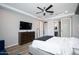 Comfortable main bedroom with ceiling fan and full dresser plus large wall-mounted TV at 2321 W Brookhart Way, Phoenix, AZ 85085