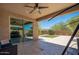 Covered patio with stone tile, outdoor furniture, and a view of the manicured backyard at 2321 W Brookhart Way, Phoenix, AZ 85085