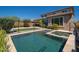 The backyard retreat has a gorgeous pool and spa with artificial turf, beautiful pavers, and mature landscaping at 2321 W Brookhart Way, Phoenix, AZ 85085