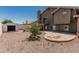 An attractive backyard features gravel, a stone patio, lush vegetation, and a shed for storing lawn and garden equipment at 2723 N Winthrop --, Mesa, AZ 85213