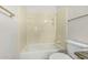 Bathroom with tub and shower combo features neutral tile surround and towel rack at 2723 N Winthrop --, Mesa, AZ 85213
