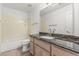 Bathroom vanity features dark granite countertop with tiled floor and tub shower combo at 2723 N Winthrop --, Mesa, AZ 85213