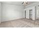 Bright bedroom with neutral carpet, ceiling fan, closet, and ensuite bathroom access at 2723 N Winthrop --, Mesa, AZ 85213