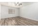 A light-filled bedroom features wood-look floors, a ceiling fan, and a window with blinds at 2723 N Winthrop --, Mesa, AZ 85213
