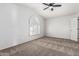 Bright bedroom features neutral carpet, ceiling fan, and a large window with shutters at 2723 N Winthrop --, Mesa, AZ 85213