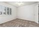 Light-filled bedroom with neutral carpet, shutters on the windows, and white walls at 2723 N Winthrop --, Mesa, AZ 85213