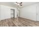 Spacious bedroom with wood-look floors, closet, ceiling fan and a hallway door at 2723 N Winthrop --, Mesa, AZ 85213
