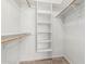 Organized closet with wood clothing rods and built in shelves at 2723 N Winthrop --, Mesa, AZ 85213