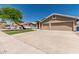 Charming two-story home boasts a three car garage, manicured lawn, and large driveway at 2723 N Winthrop --, Mesa, AZ 85213