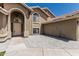 Charming entrance with arched doorway, neutral color palette, and beautiful front yard at 2723 N Winthrop --, Mesa, AZ 85213