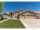 Charming two-story home boasts a three car garage, manicured lawn, and neutral color palette at 2723 N Winthrop --, Mesa, AZ 85213