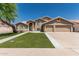 Charming two-story home boasts a three car garage, manicured lawn, and neutral color palette at 2723 N Winthrop --, Mesa, AZ 85213