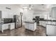 Bright kitchen features stainless steel appliances, white cabinets, and an island at 2723 N Winthrop --, Mesa, AZ 85213