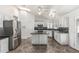 Spacious kitchen with stainless appliances, island, and white cabinets at 2723 N Winthrop --, Mesa, AZ 85213