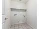 Bright laundry room with tile flooring, built-in shelf, and utility hookups at 2723 N Winthrop --, Mesa, AZ 85213