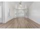 Bright living room featuring white walls, wood floors, and multiple windows with shutters at 2723 N Winthrop --, Mesa, AZ 85213