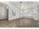 Bright living room with wood floors, arched windows, and a decorative light fixture at 2723 N Winthrop --, Mesa, AZ 85213