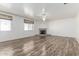 Spacious living room with wood floors, a fireplace, and windows with custom blinds at 2723 N Winthrop --, Mesa, AZ 85213