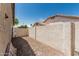 View of the gravel side yard with block wall and metal gate at 2723 N Winthrop --, Mesa, AZ 85213
