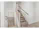 Carpeted staircase leads to a living room with wood floors and fan at 2723 N Winthrop --, Mesa, AZ 85213