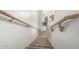 A carpeted staircase descends, offering a view into the tiled kitchen with stainless steel appliances at 2723 N Winthrop --, Mesa, AZ 85213