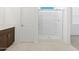The bathroom features a double sink vanity, tiled floor and a glass enclosed shower at 37153 W Prado St, Maricopa, AZ 85138