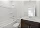 Clean, bright bathroom featuring a tub, shower, and a modern vanity with a dark wood cabinet at 37153 W Prado St, Maricopa, AZ 85138