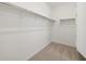 A walk-in closet with plenty of hanging space and carpeted floor at 37153 W Prado St, Maricopa, AZ 85138
