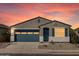 Charming single-story home featuring a blue garage door and shutters against a grey stucco exterior and landscaped front yard at 37153 W Prado St, Maricopa, AZ 85138