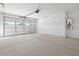 Spacious garage with a large sectional door and concrete flooring, providing ample space for parking and storage at 37153 W Prado St, Maricopa, AZ 85138