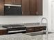 Granite countertops, stainless steel appliances, and modern fixtures enhance the kitchen at 37153 W Prado St, Maricopa, AZ 85138
