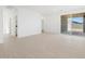 Bright living area with recessed lights, tile flooring, and sliding glass doors to the backyard at 37153 W Prado St, Maricopa, AZ 85138
