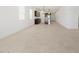 Open concept living room, dining room, and kitchen with tiled floors and stainless steel appliances at 37153 W Prado St, Maricopa, AZ 85138