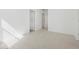 Bright room with neutral tile flooring and multiple doorways at 37153 W Prado St, Maricopa, AZ 85138