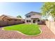 Well-maintained backyard featuring an irrigation system, desert landscaping, and rear home view at 379 E Cheyenne Rd, San Tan Valley, AZ 85143