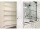 A modern bathroom featuring a marble-tiled shower with glass door and built-in shelving for storage at 379 E Cheyenne Rd, San Tan Valley, AZ 85143